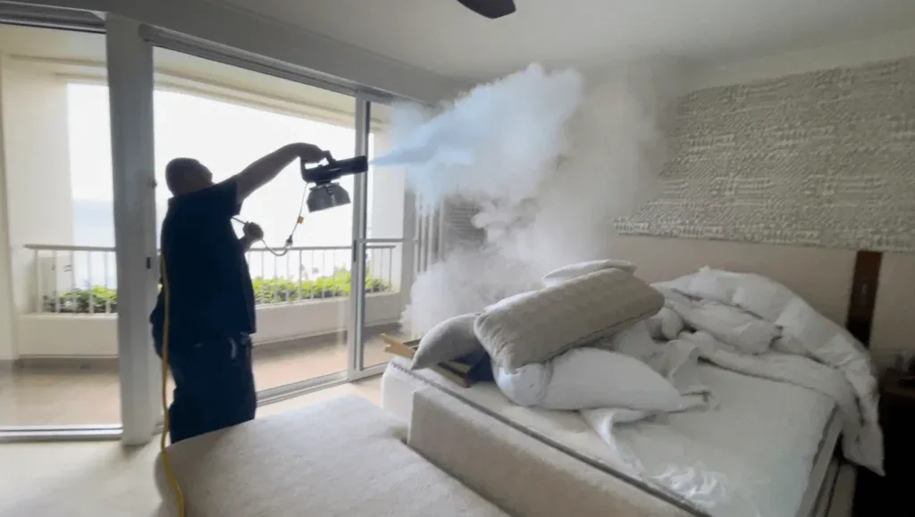 Renue Hawaii technician using a fogger with nicotine counteractant for commercial smoke odor removal in Kapolei